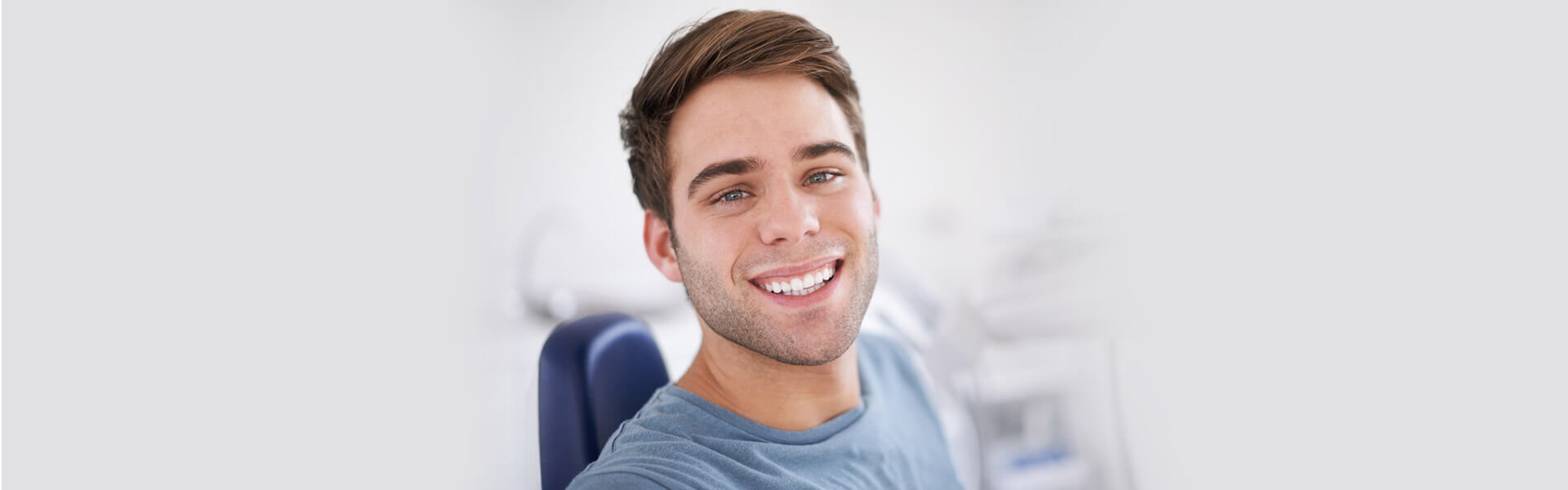 A guy smiling after Dental Crown treatment